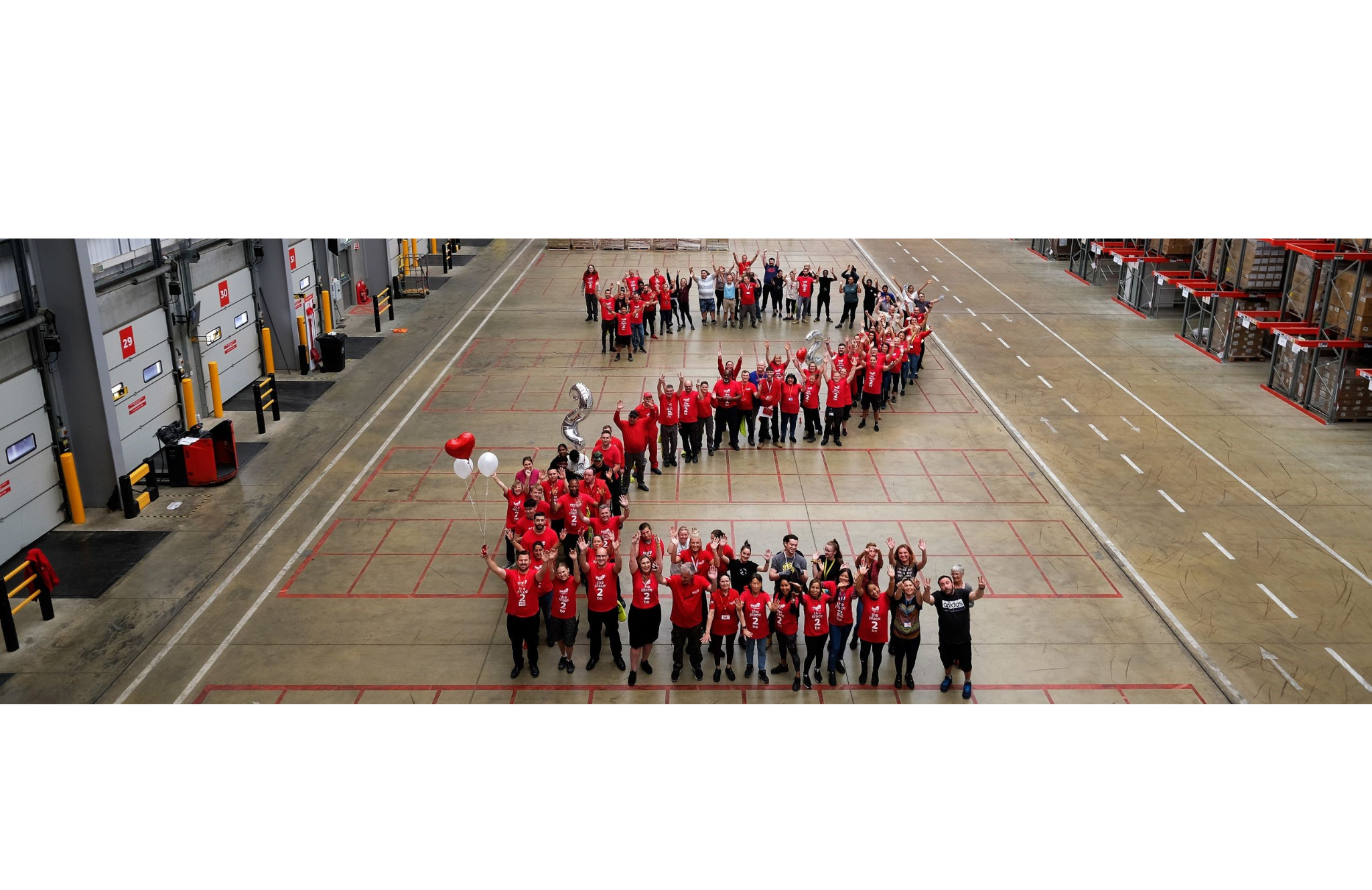 Corby warehouse team stood in 2 formation