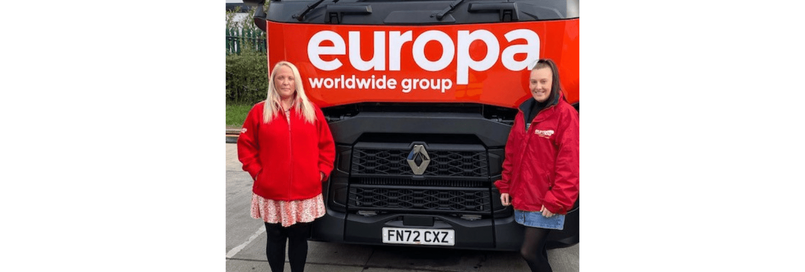 Sarah Elliott stands in front of red, branded Europa truck
