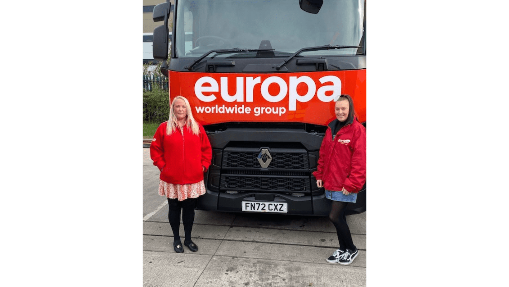 Sarah Elliott stands in front of red, branded Europa truck
