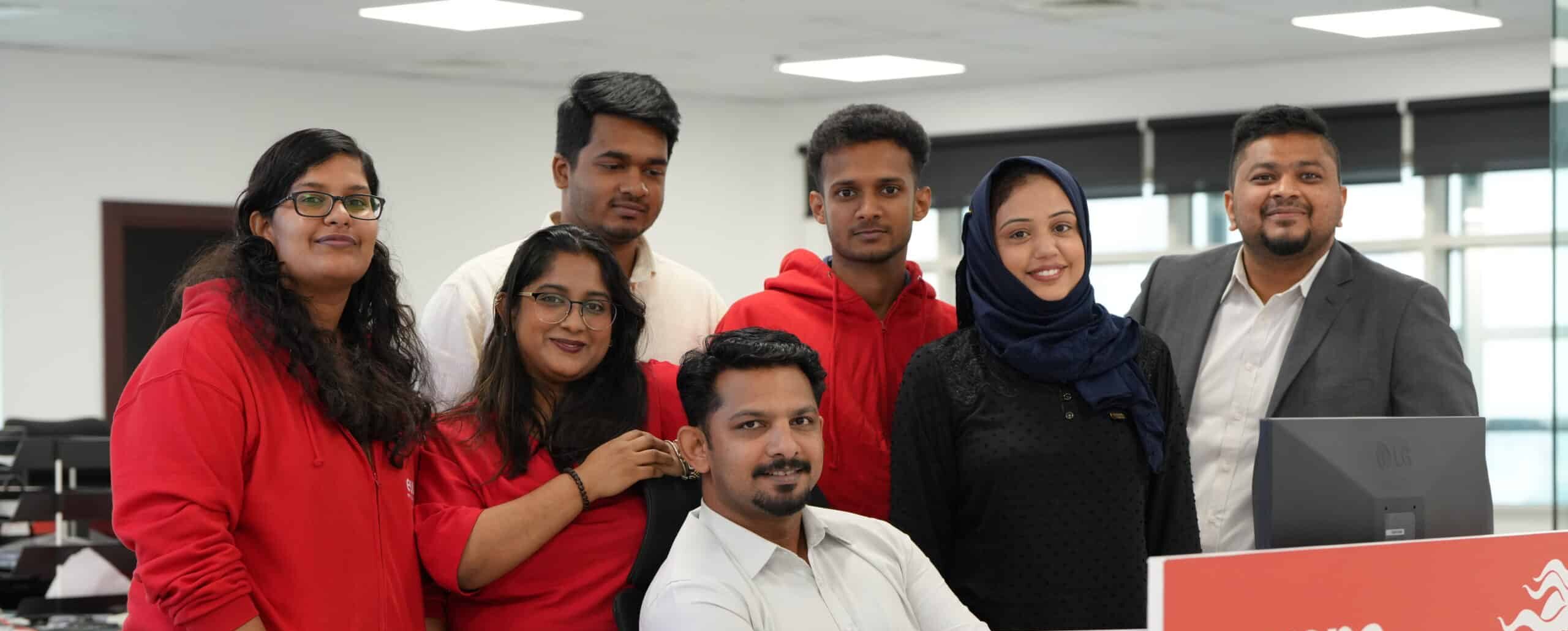 The Dubai team around a computer in Europa office.